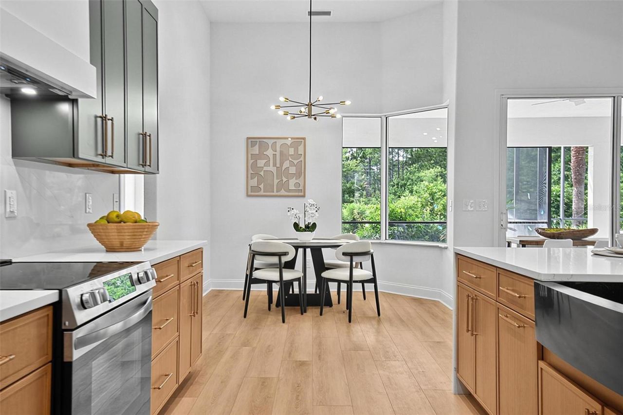 Photo 16 of 20: The kitchen looking out at the cozy breakfast nook that extends a beautiful view of the outdoors while you have your morning coffee or your casual dining.