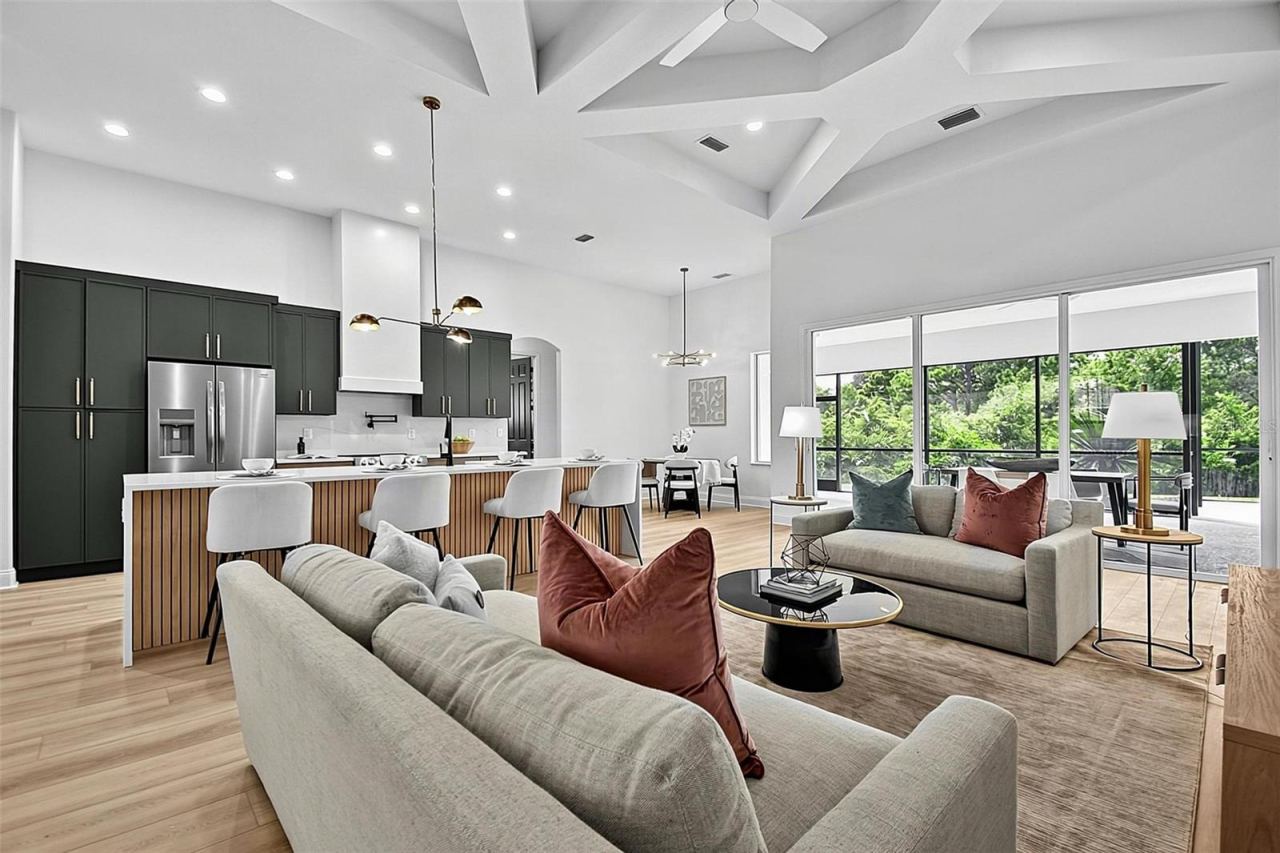 Photo 9 of 20: Step inside the open concept living room with the enormous high coffered ceilings that set the tone for the living room/dining room/ breakfast nook into a fully renovated kitchen that flows effortlessly together.