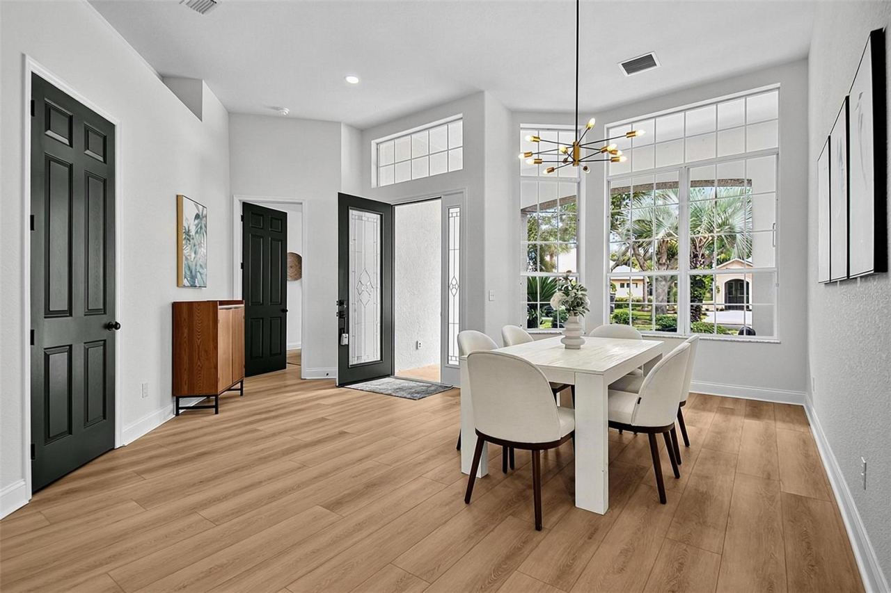 Photo 6 of 20: Large expanse of window let in light to reflect the warm and airiness of the formal dining room, entry and leading into the 3rd bedroom/office/ den