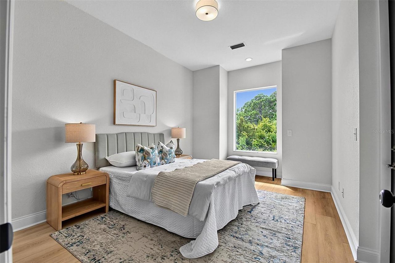 Photo 18 of 20: This spacious 3rd guest bedroom has a charming bench nook in the window and access through a back door to the huge covered screened lanai area..