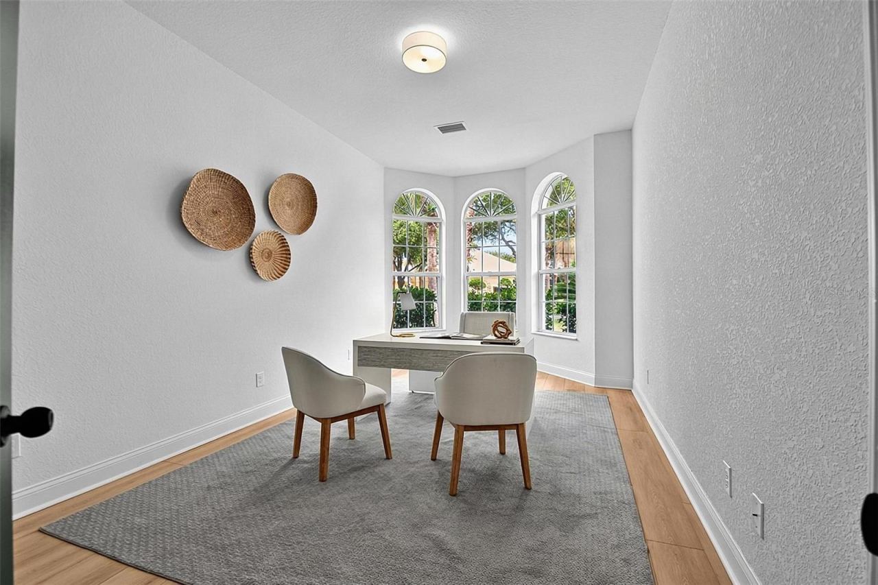 Photo 8 of 20: The 2nd guest bedroom features high curved Bay area windows giving lots of natural light. This bedroom can be used as an office shown here or a den.