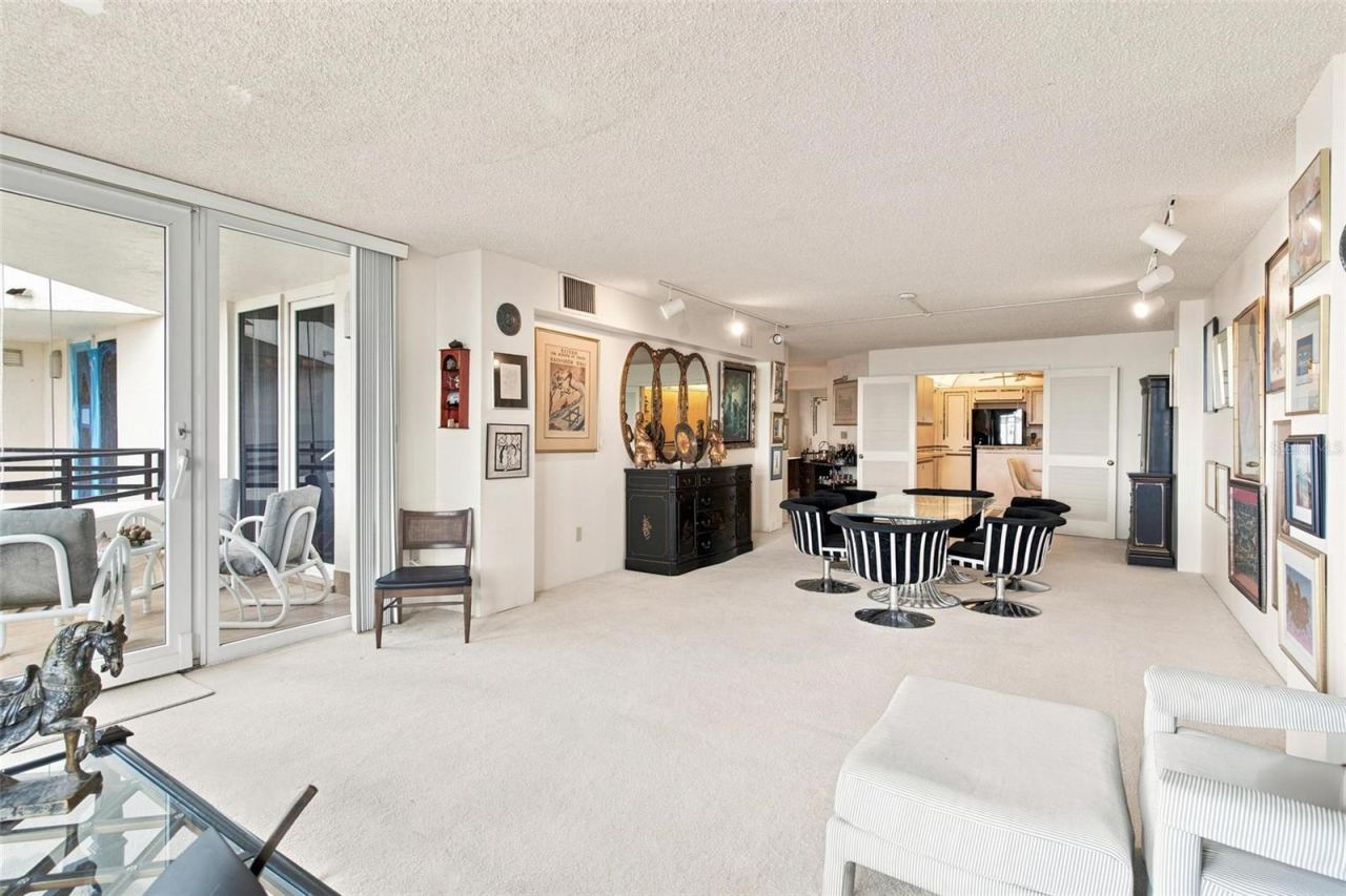 Photo 20 of 20: Open Living Space. Dining and Living Area overlook Kitchen and has sliders leading to balcony with ocean view.