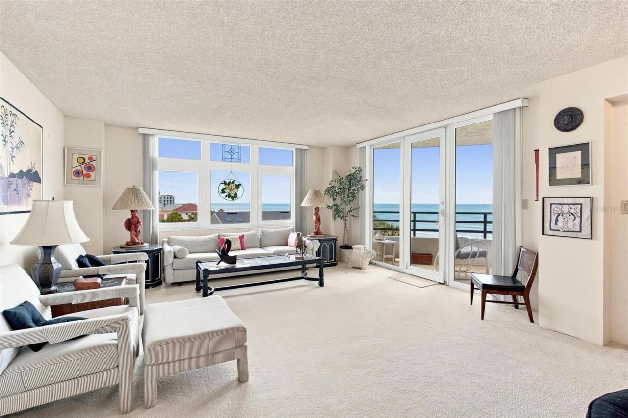 Photo 16 of 20: Open Living Space. Dining and Living Area with sliders leading to balcony with ocean view.