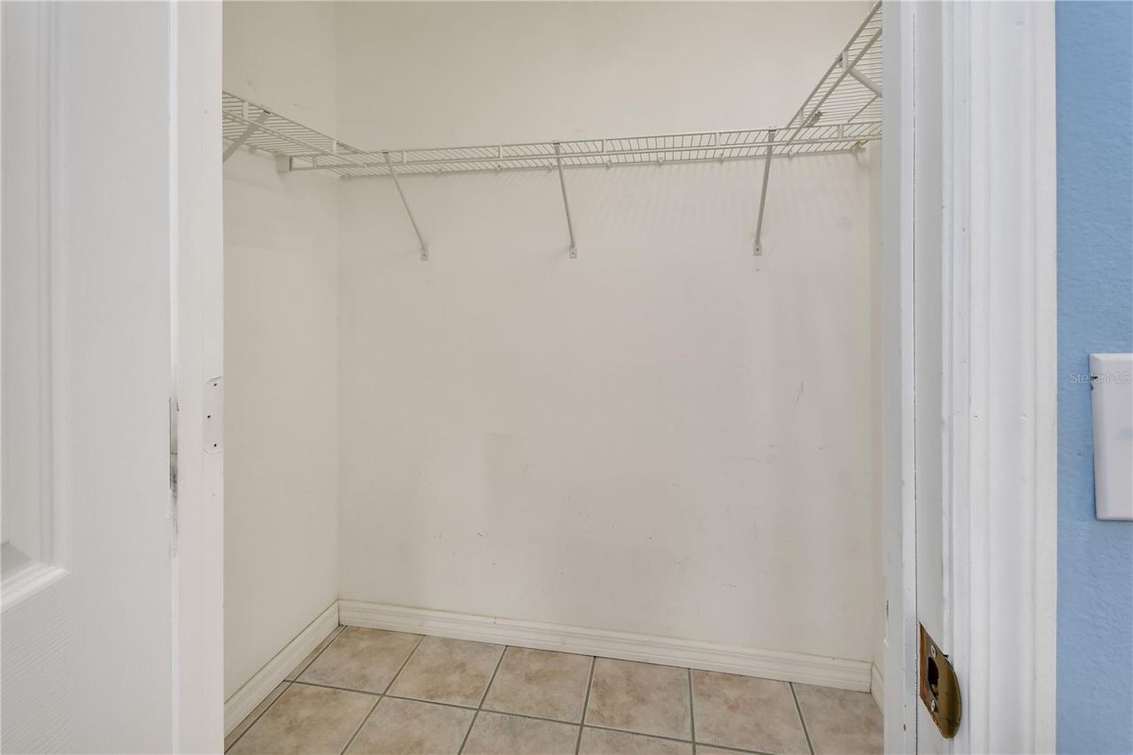 Photo 19 of 20: Primary bedroom walk in closet
