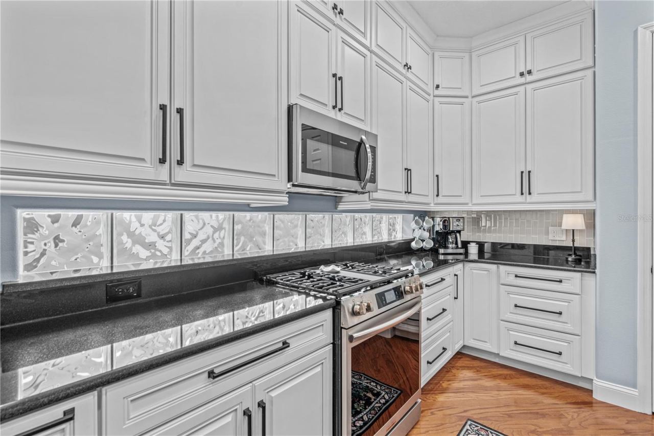 Photo 20 of 20: Granite on the perimeter counters with the glass block windows providing even more natural light; And check out all those drawers!