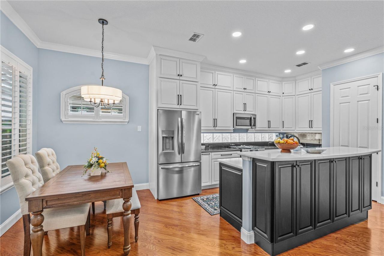 Photo 17 of 20: The renovated kitchen offers tons of storage-- there are even cabinets under the breakfast bar!