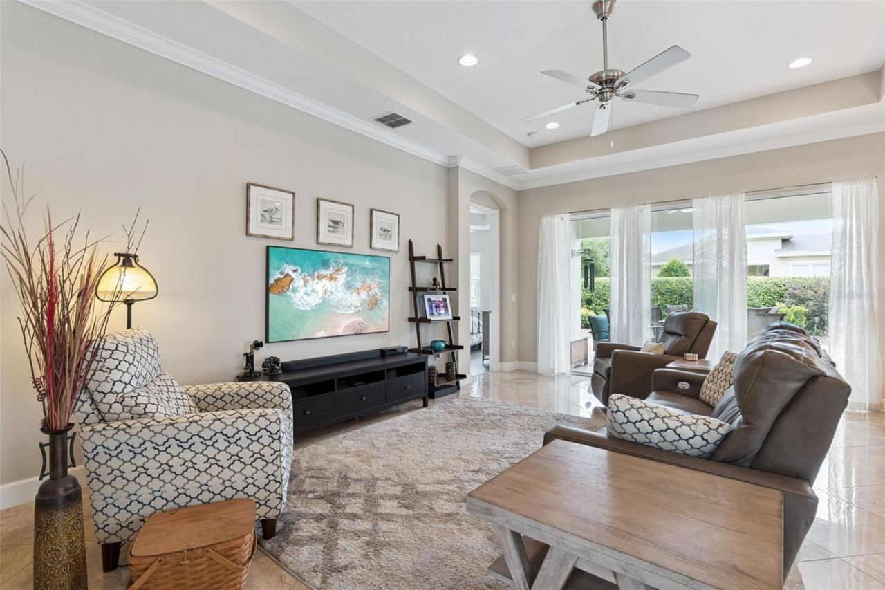 Photo 5 of 20: 15' x 20' Great Room w/ porcelain tile floor, tray ceiling, recessed lighting & crown molding