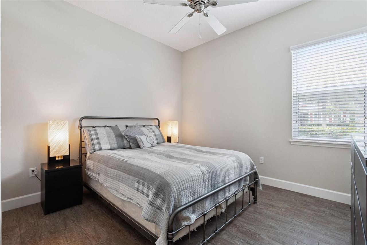 Photo 20 of 20: 11' x 12'6" Bedroom #2 w/ porcelain plank tile & a ceiling fan