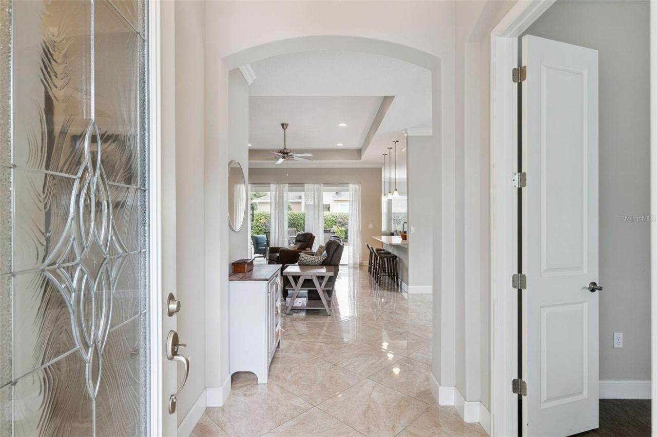 Photo 2 of 20: Foyer entryway w/ porcelain tile floor, 5" baseboards & leaded glass front door w/ sidelight...