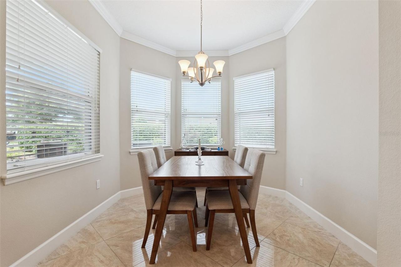 Photo 13 of 20: 10' x 11'6" Dinette area overlooking backyard w/ lush landscaping & a privacy hedge