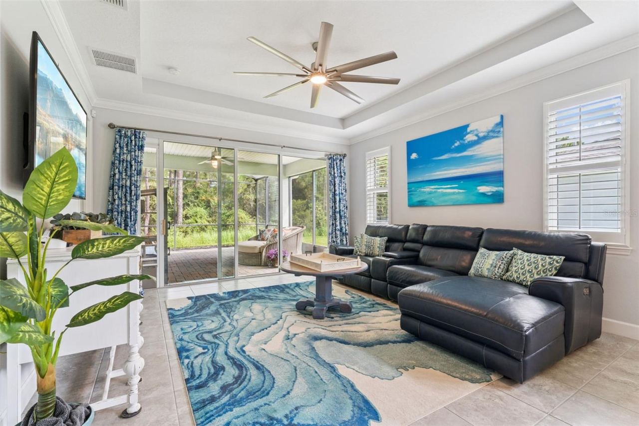 Photo 11 of 20: 15' x 15' Great Room w/ Plantation style shutters & a conservation area view