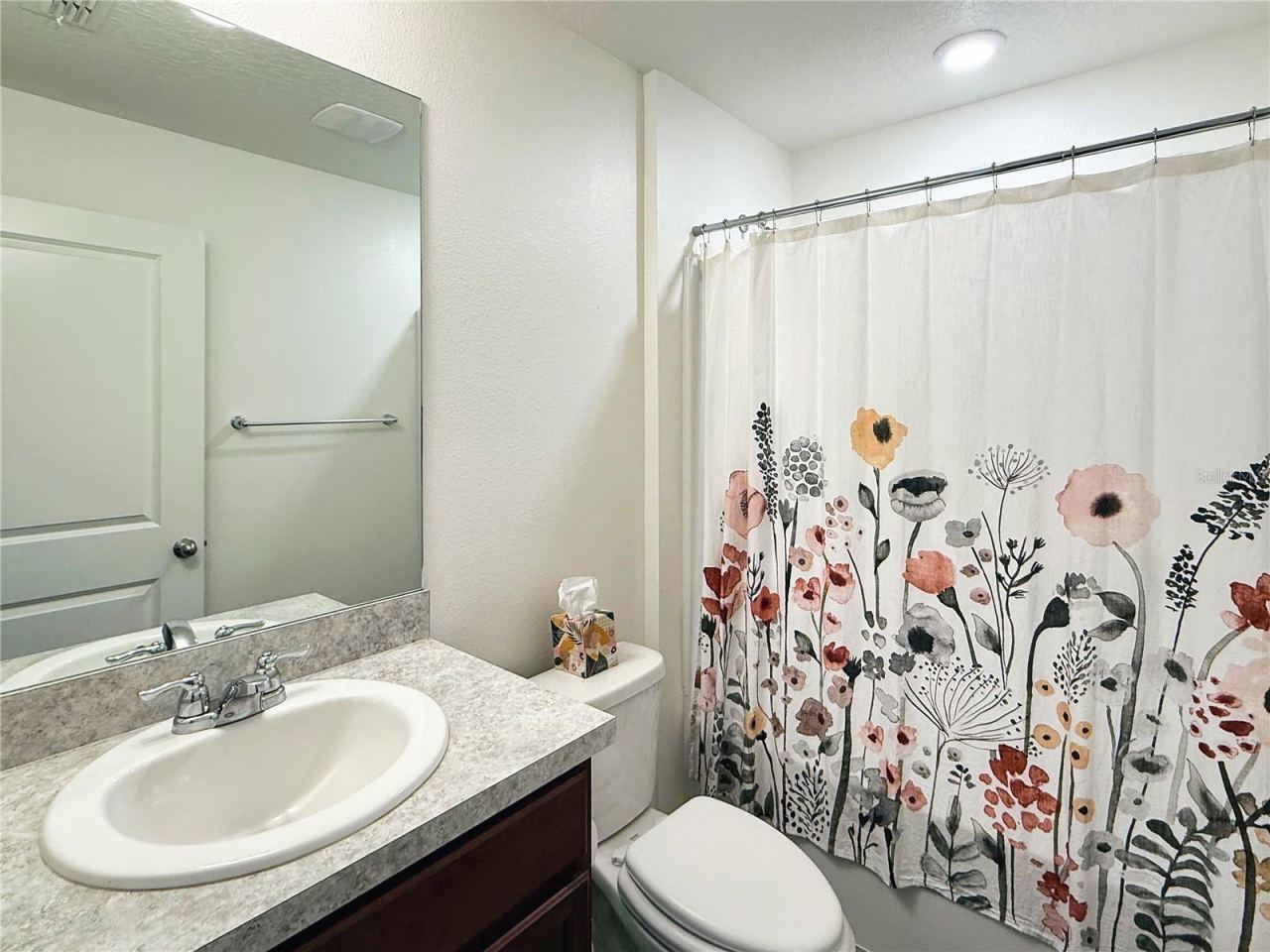 Photo 17 of 20: Bright and well-kept, this guest bath offers a clean, comfortable design with attractive vanity space and a full tub-shower combination for everyday convenience.