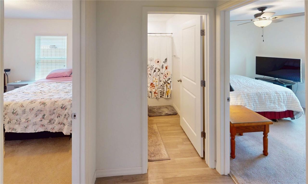 Photo 15 of 20: Guest Suite Transition Hallway; Access to front and rear bedrooms between full bathroom serving both bedrooms