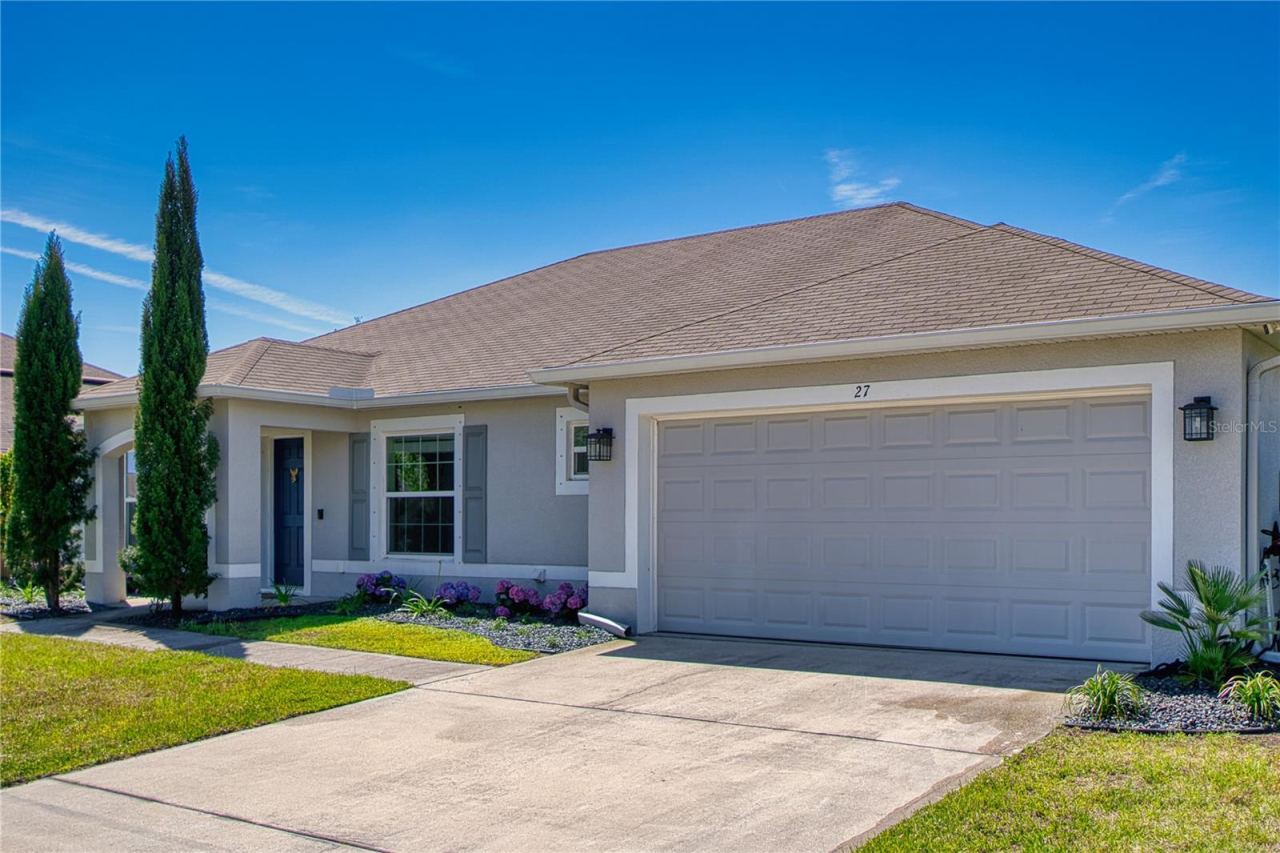 Photo 4 of 20: Wide driveway, two-car garage, and a soft neutral exterior palette give this front elevation a clean, upscale look, while the arched entry adds a touch of architectural charm.