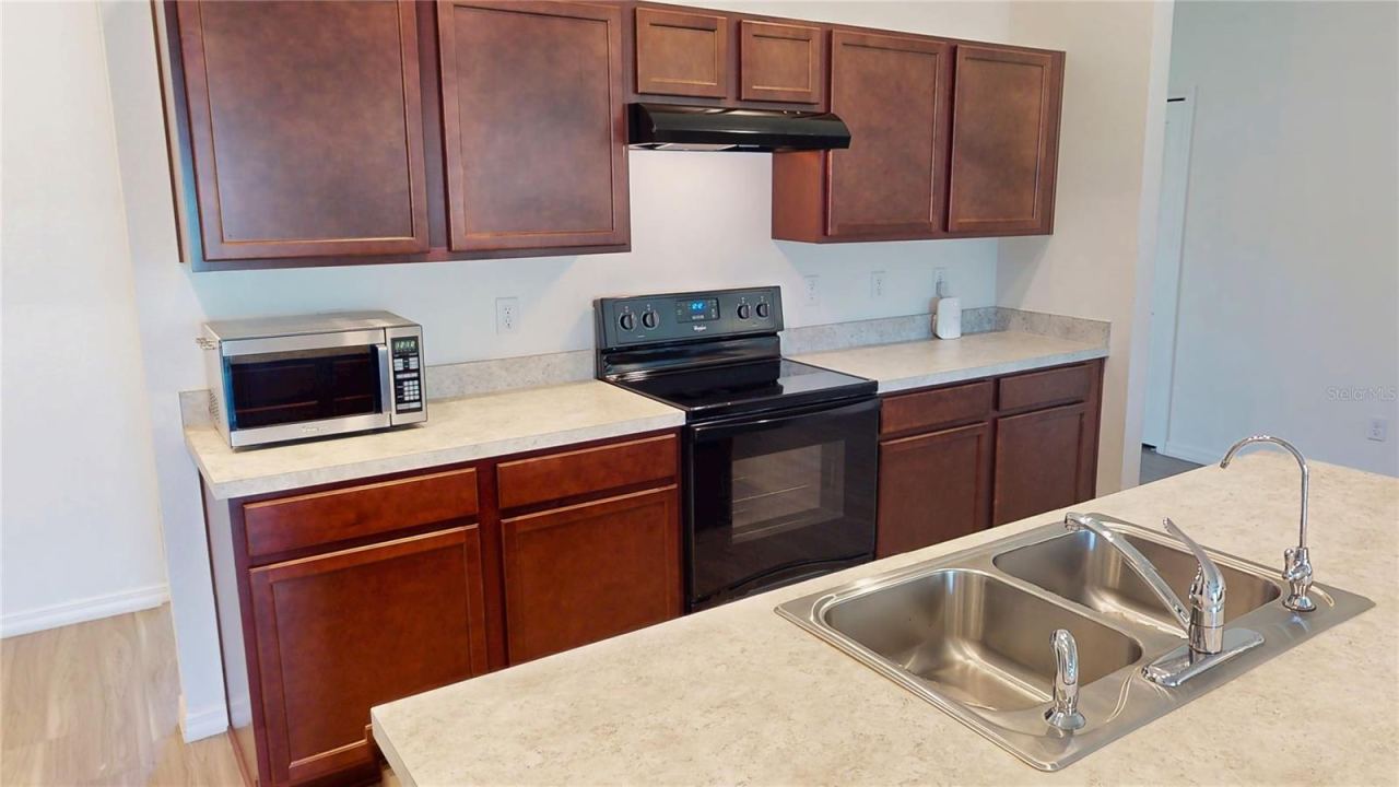 Photo 13 of 20: Plenty of counter space and cabinetry with a clean appliance wall, great task lighting, and an easy prep-to-cook flow—everything stays within reach without feeling cramped.