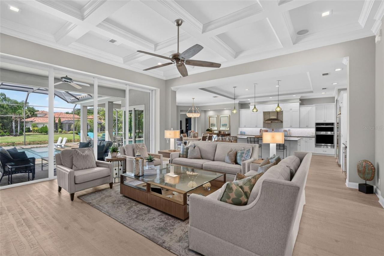Photo 4 of 20: The heart of the home unfolds in one beautiful, open sweep—designed for effortless conversation, entertaining, and everyday living. Custom details overhead and wide-plank hardwood underfoot give the space a polished yet welcoming feel.