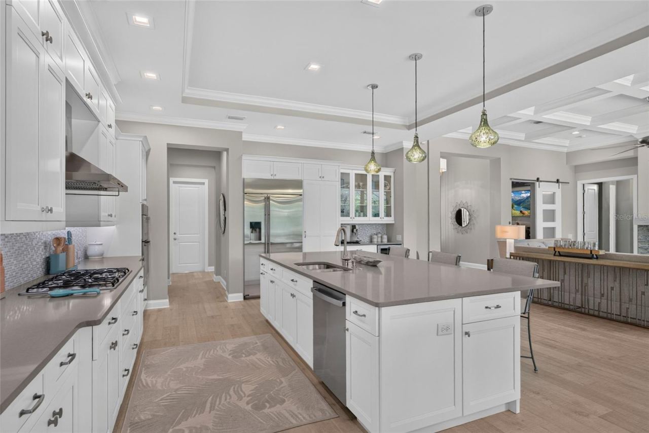 Photo 20 of 20: Generous workspace meets thoughtful design, with an expansive center island, extensive storage and a layout that gives the kitchen a commanding presence without sacrificing function.