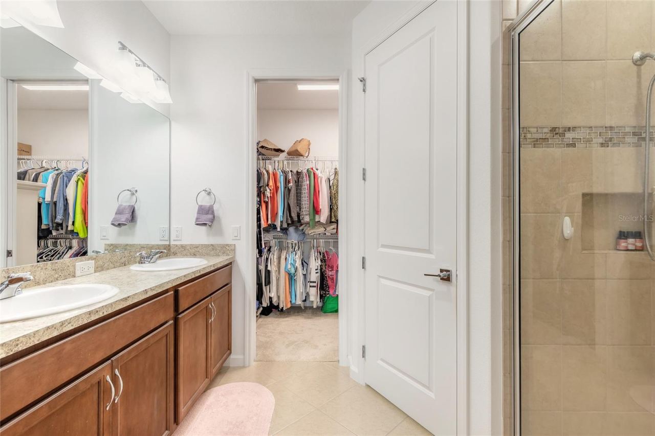 Photo 20 of 20: Primary ensuite bathroom with shower and large walk-in closet