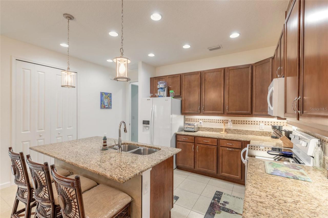 Photo 14 of 20: Kitchen island with bar seating & tile kick plate