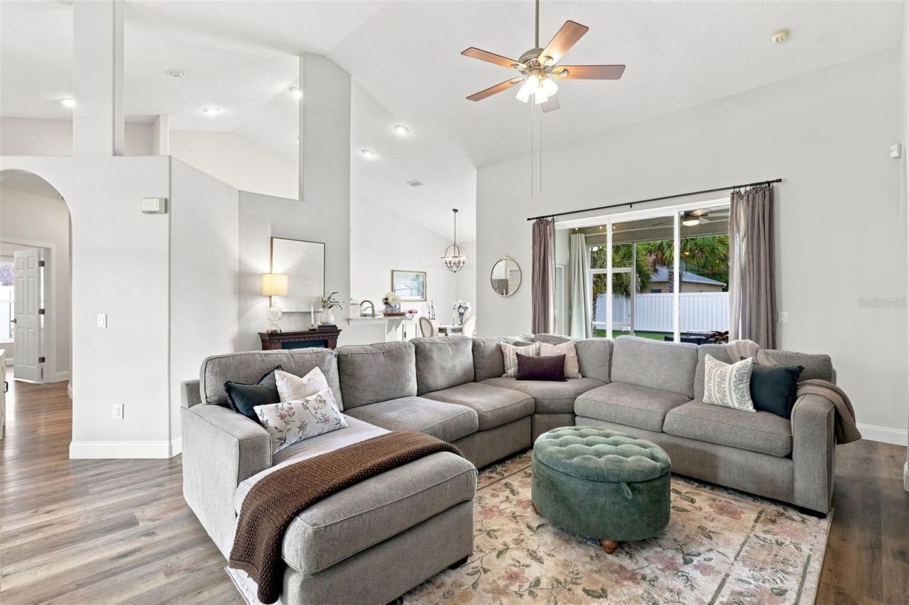 Photo 13 of 20: Main living area towards triple pocket sliders and the screened lanai.