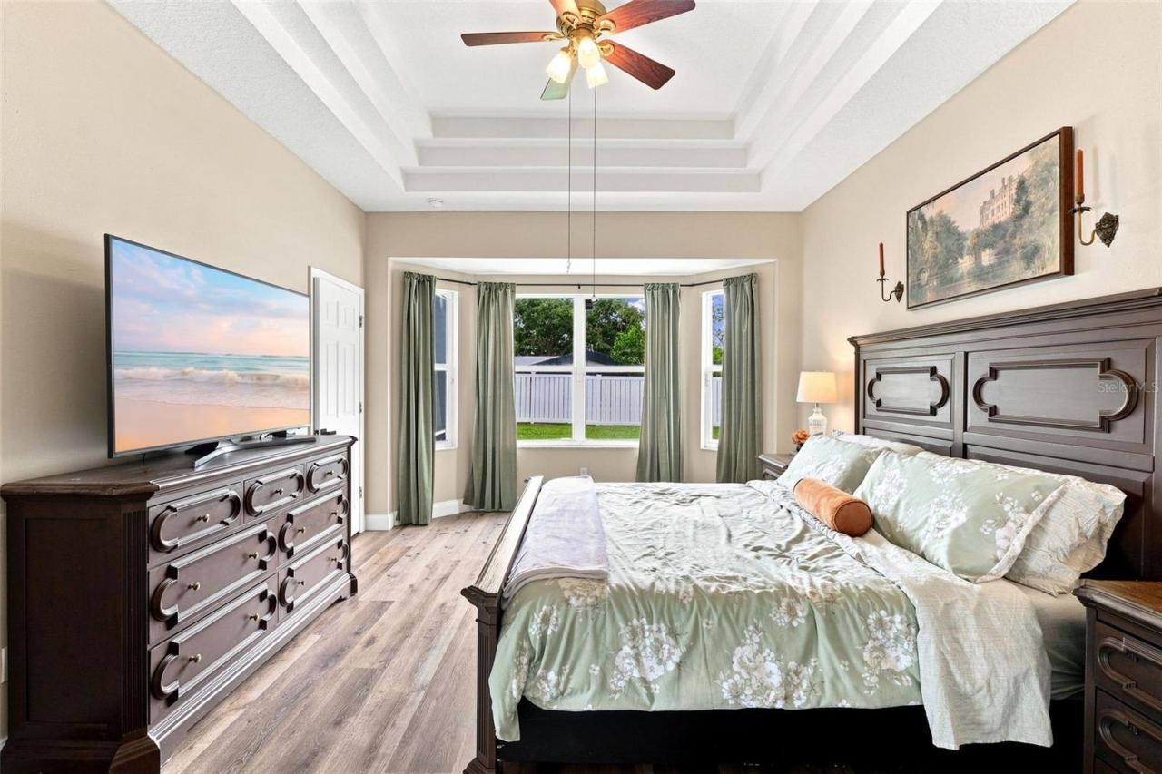 Photo 3 of 20: Primary bedroom with bay window view.