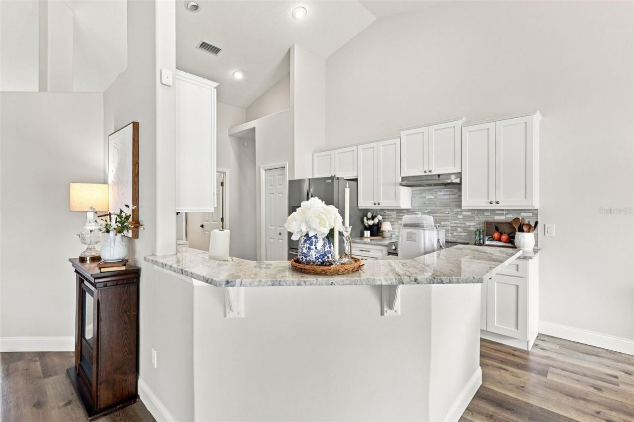 Photo 9 of 20: Breakfast bar with granite countertops. Kitchen remodel in 2026.