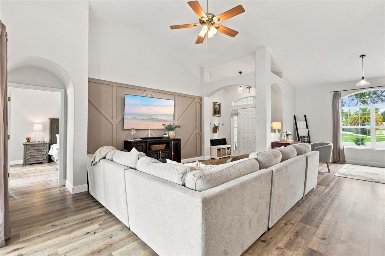 Photo 12 of 20: Main living area with primary bedroom suite at left. The soaring ceilings make this home feel even larger than it is.