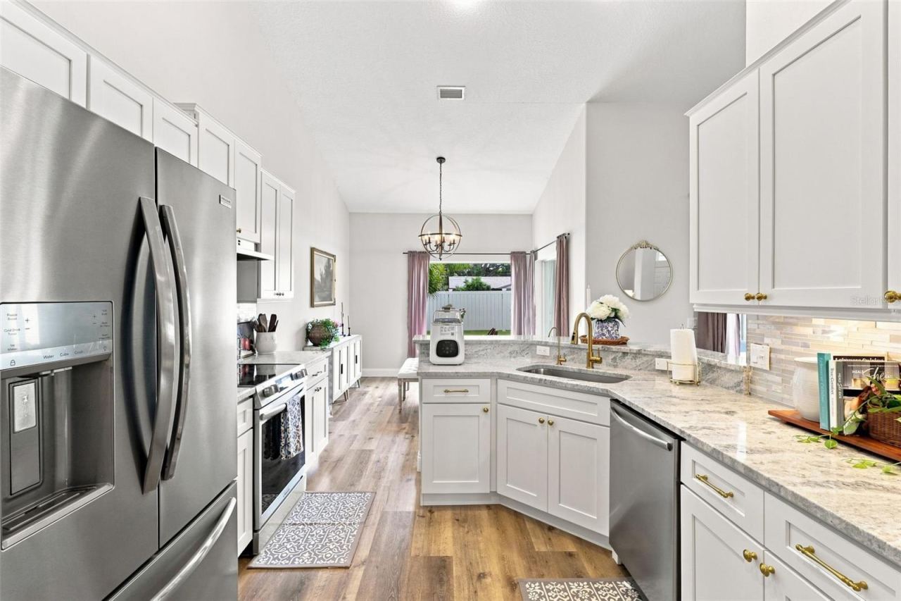 Photo 8 of 20: Updated kitchen with tons of soft-close cabinetry, stainless steel appliances and custom backsplash.