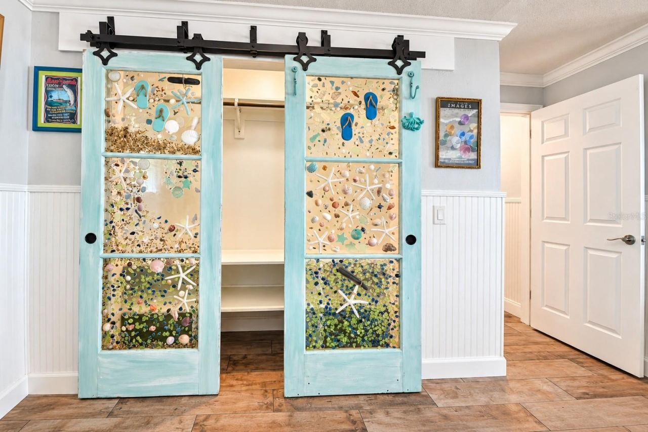 Photo 20 of 20: Primary bedroom closet with custom glass barn doors.
