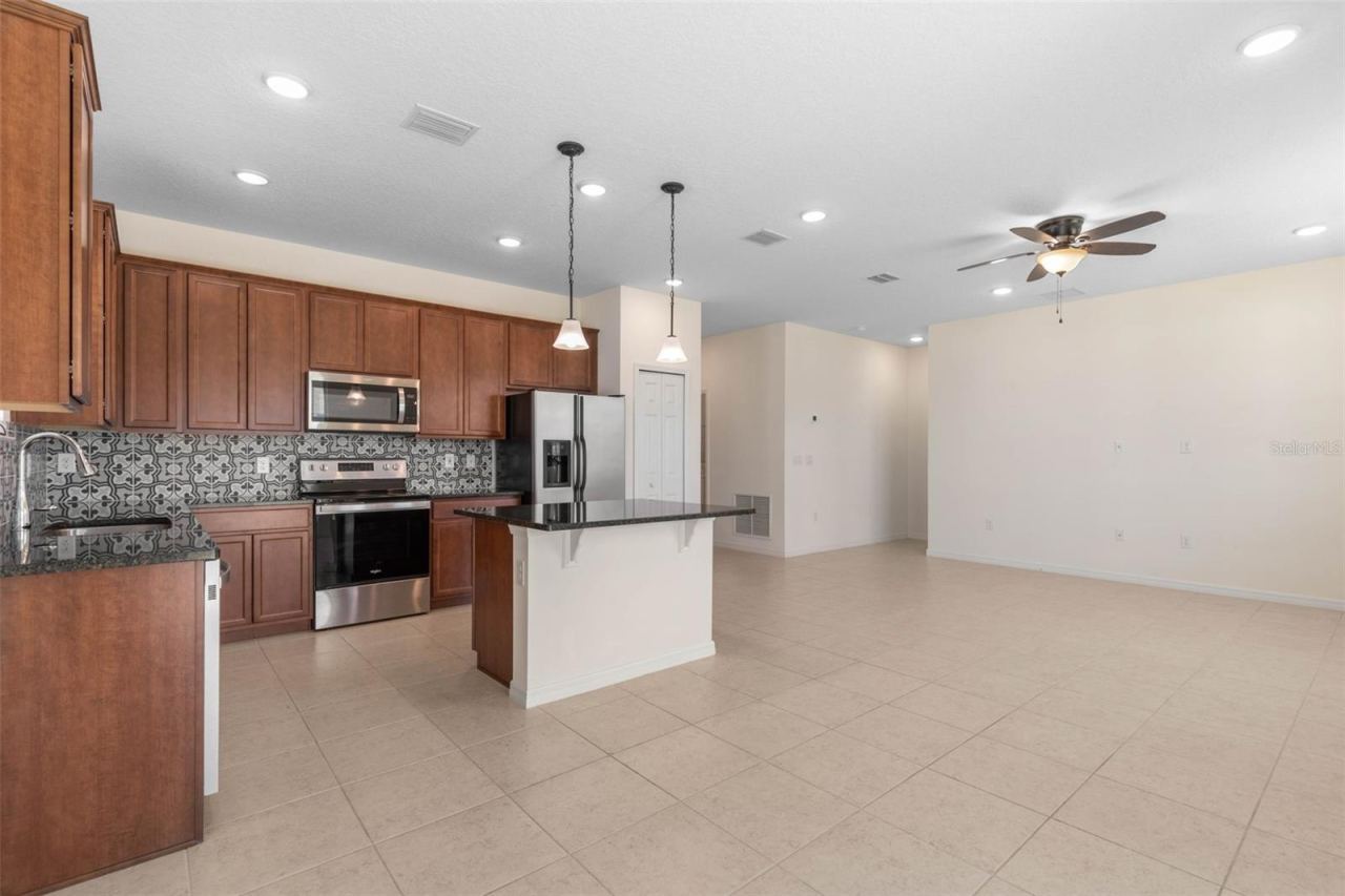 Photo 16 of 20: Functional kitchen with stainless steel appliances, generous cabinetry, and a center island for added workspace.