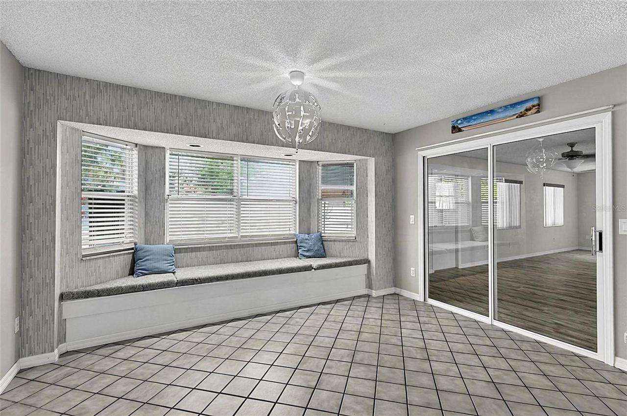 Photo 16 of 20: Eat-In Kitchen with Cozy Nook and Sliding Door To Florida Room