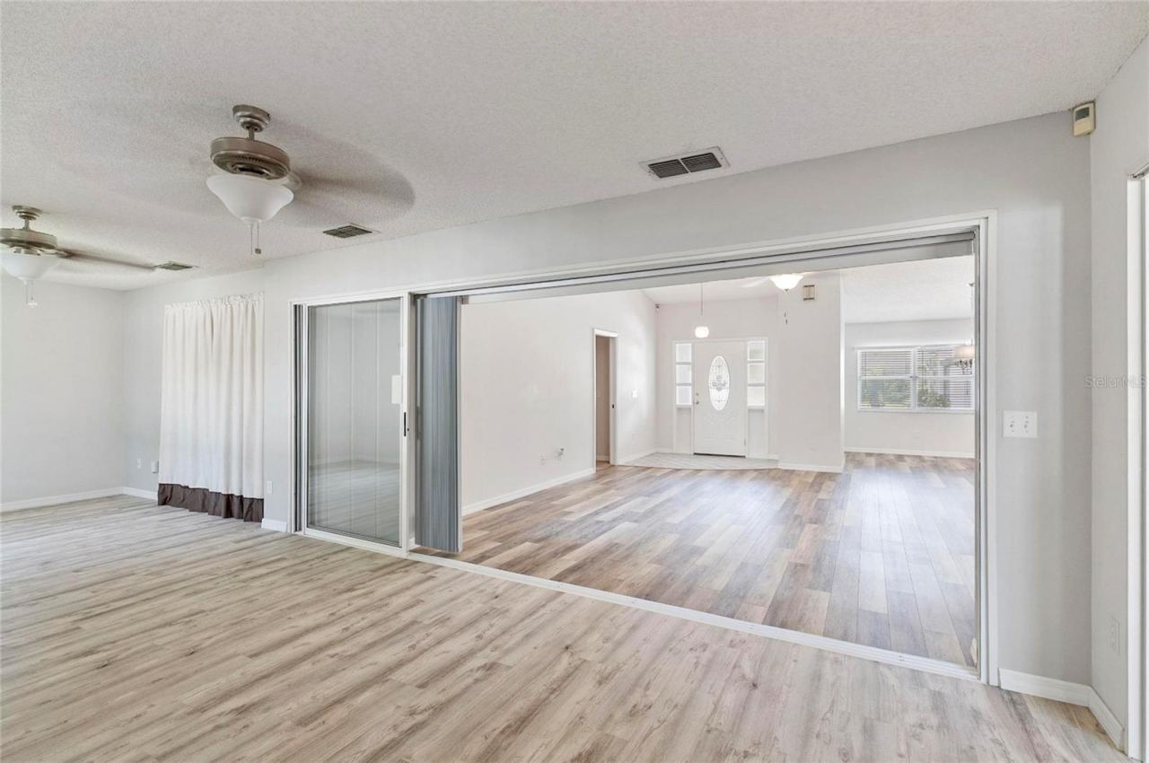 Photo 13 of 20: Florida Room with Triple Sliding Door To Living Room