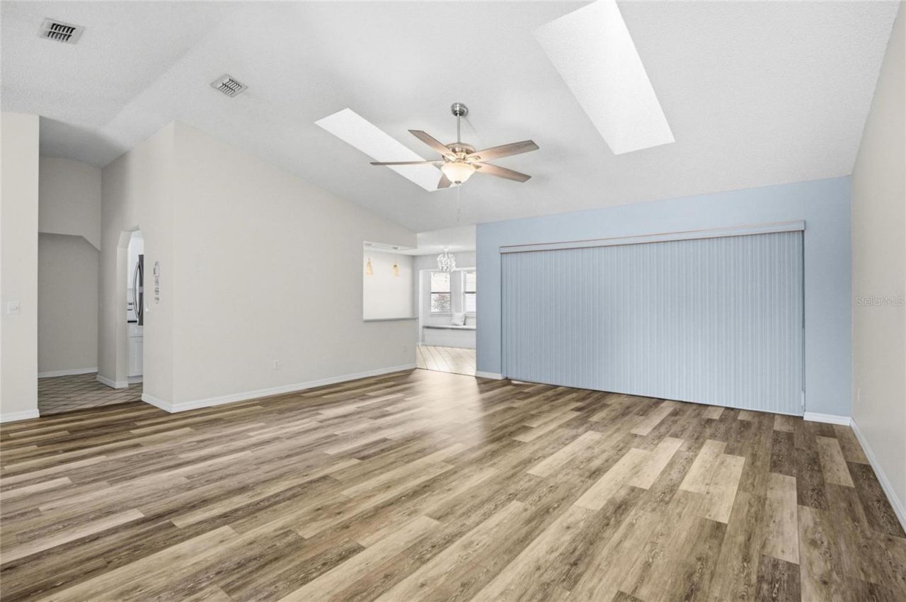 Photo 11 of 20: Living Room with Triple Sliding Door To Florida Room