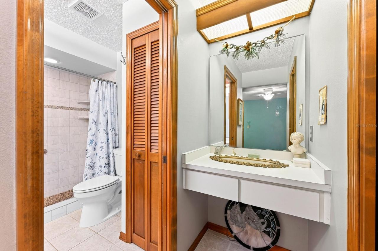 Photo 18 of 20: A makeup/vanity space sits between the Primary walk-in closet and en suite Bath.