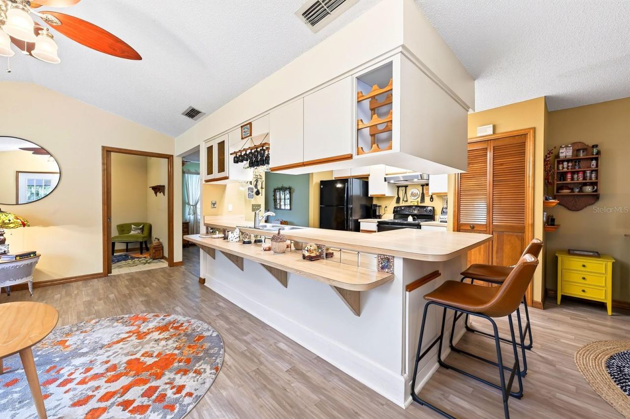 Photo 13 of 20: A GENEROUS KITCHEN BREAKFAST BAR makes meal preparation and casual gathering easy.