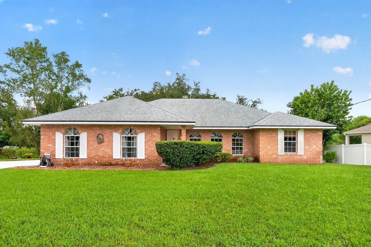 Photo 1 of 20: Meticulously maintained and full of inviting spaces, this CHARMING 3-Bedroom, 2-Bath home offers comfortable Florida living on an OVERSIZED LOT with mature trees.