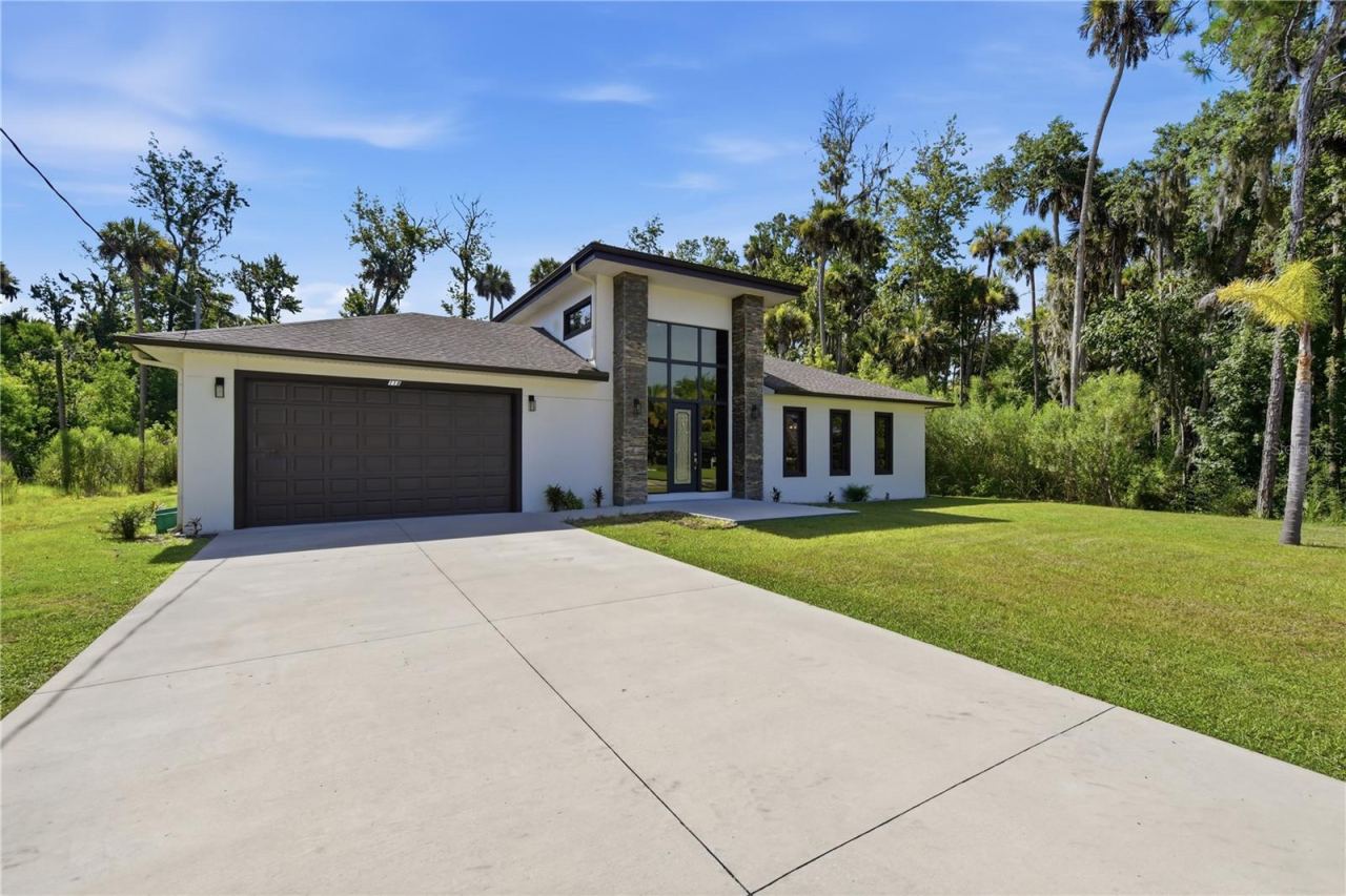 Photo 2 of 20: Oversized two-car garage with ample driveway parking.