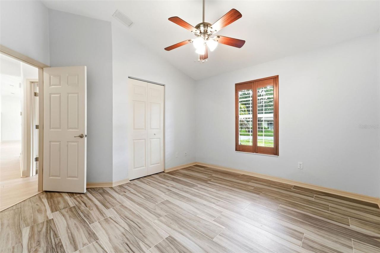 Photo 10 of 20: Bedroom two with built in closet and plantation shutters.