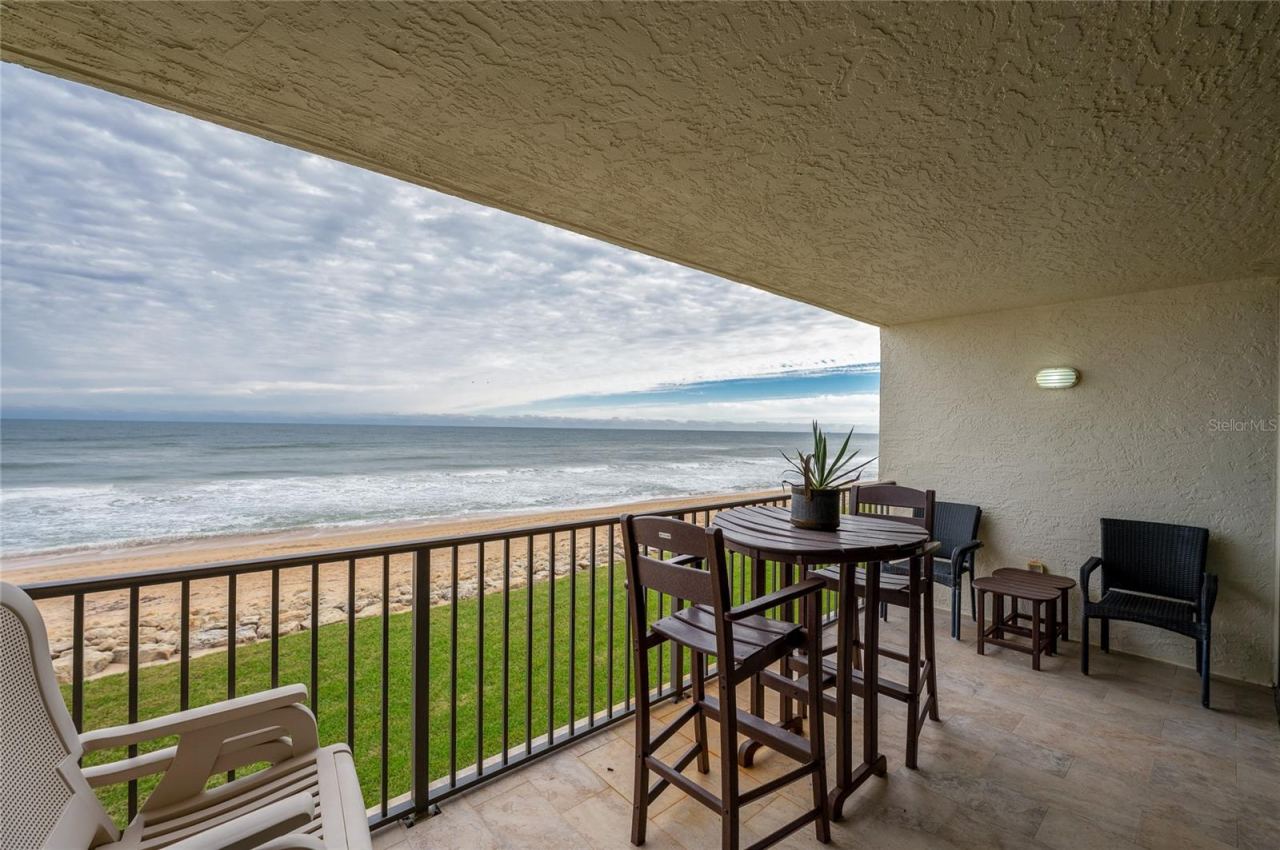 Photo 20 of 20: The private covered balcony offers a front-row seat to the Atlantic, with space for dining or lounging while taking in uninterrupted ocean views and the sound of crashing waves.