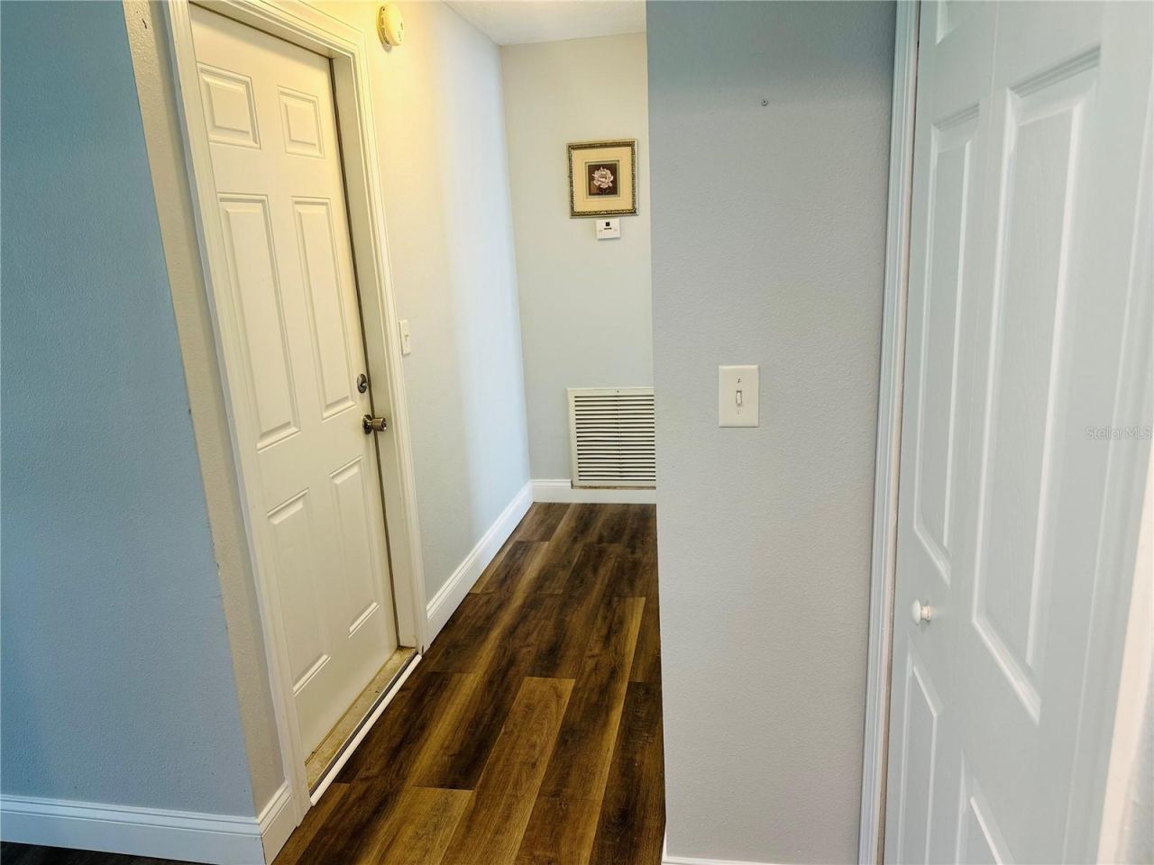 Photo 12 of 20: hallway to master bedroom and garage door on left