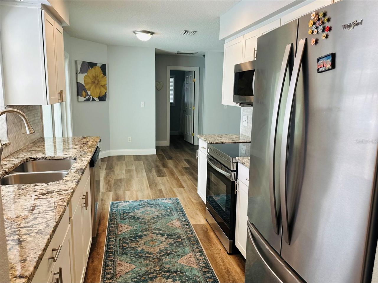 Photo 6 of 20: Kitchen looking towards hallway to garage and master bedroom
