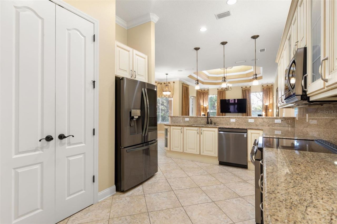 Photo 3 of 20: Italian-inspired cabinetry, granite countertops and backsplash bring timeless elegance to this thoughtfully designed kitchen.