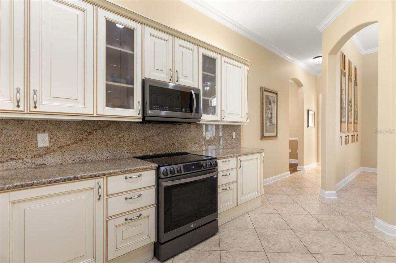 Photo 7 of 20: Beautifully detailed cabinetry, glass-front accents and graceful archways add character and architectural charm.