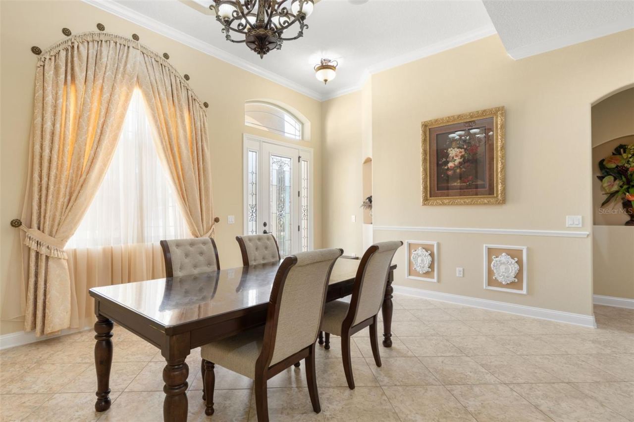 Photo 16 of 20: Beautiful window treatments, decorative wall molding and soft natural light create a welcoming atmosphere for memorable dinners and special occasions.
