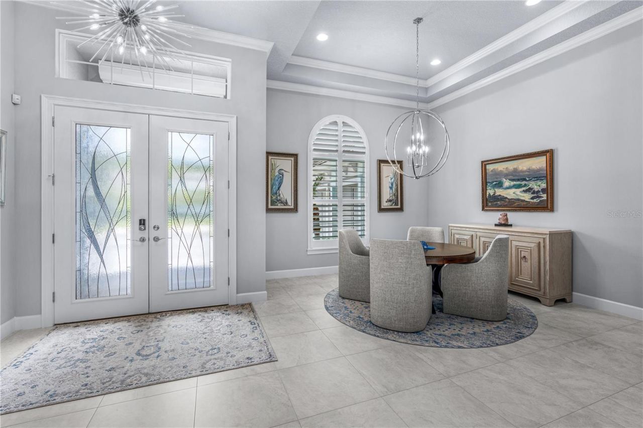 Photo 6 of 20: Front Door EntranceTray Ceiling, Light Fixture, Transom Window, and Double Glass Doors