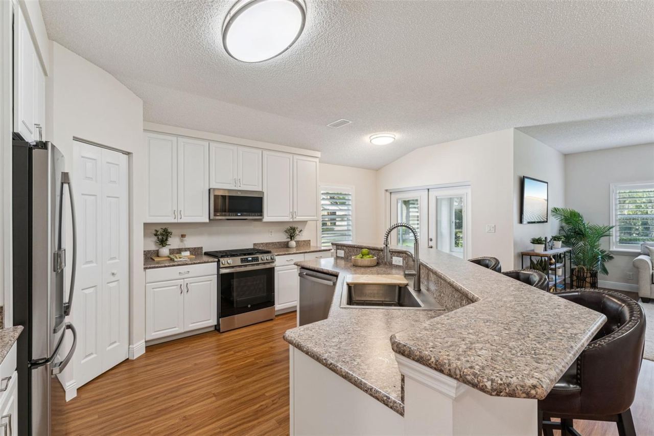 Photo 6 of 20: 13'6" x 12' Kitchen w/ 42" "soft close" cabinets, laminate countertop, large single basin sink & stainless steel appliances