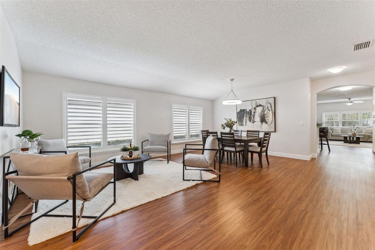 Photo 2 of 20: View of the Living & Dining Room areas w/ Plantation style shutters & a laminate floor