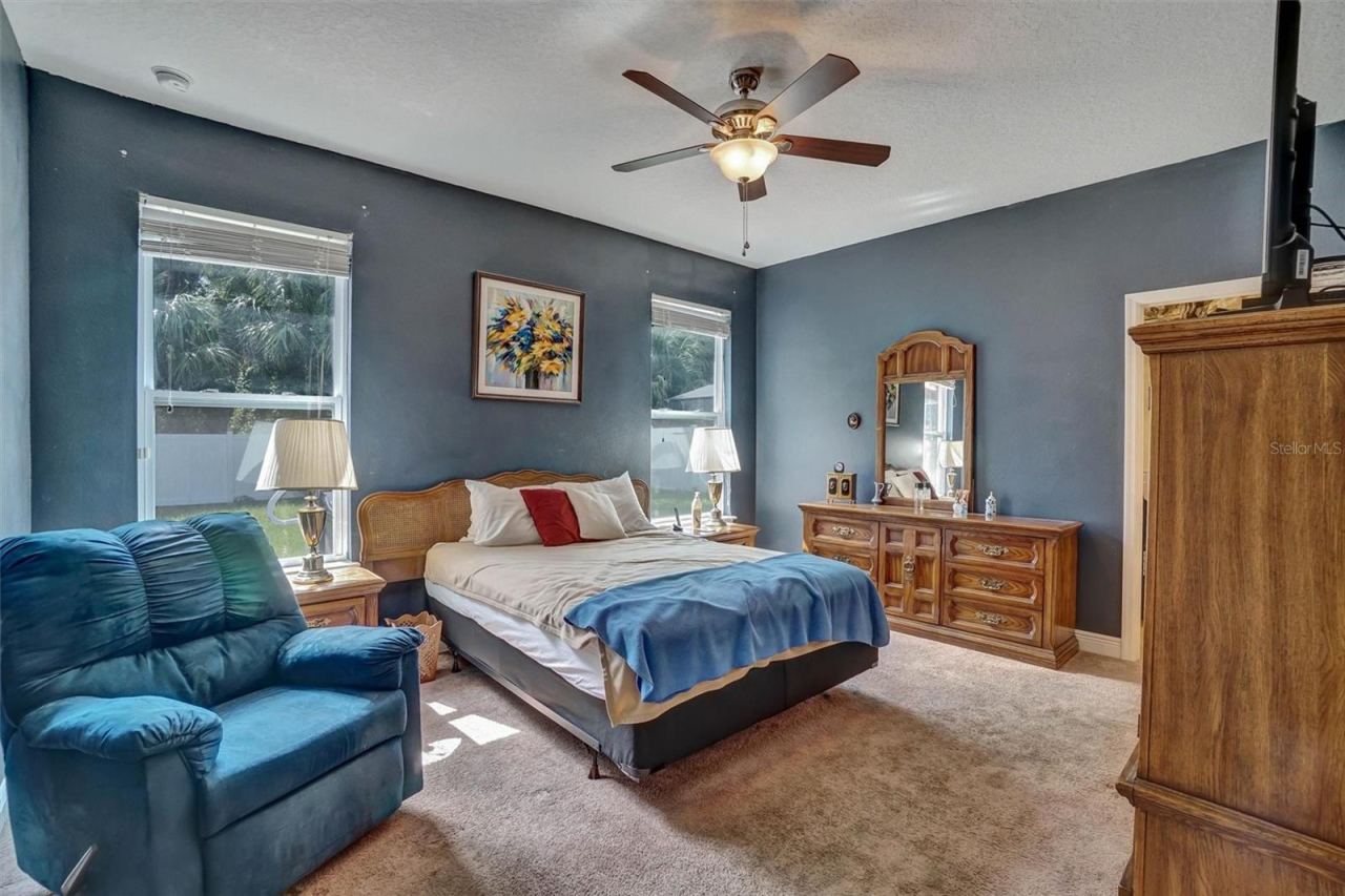 Photo 12 of 20: Primary BedroomSpacious primary bedroom with ceiling fan, and abundant natural light.