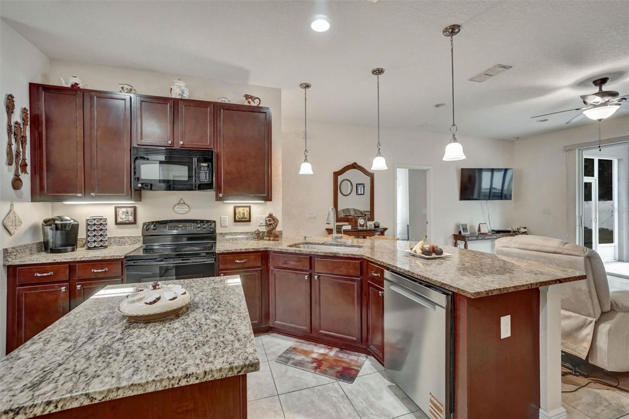Photo 10 of 20: KitchenKitchen with ample cabinetry, granite countertops, and convenient storage.