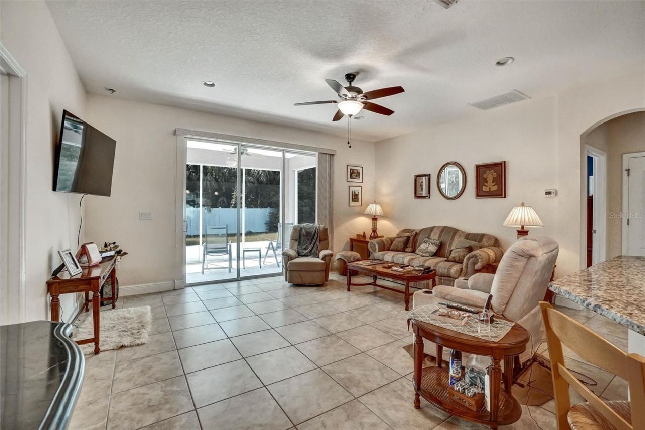 Photo 6 of 20: Bright living room overlooking the covered patio through sliding glass doors.